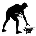 Black silhouette of a man operates unmanned quadcopter vector illustration