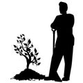 Black silhouette of men in work clothes with shovel stand next to young tree in heap of ground, isolated on white. Design element