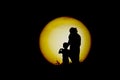 The black silhouette of Mom and kids watching the moon Royalty Free Stock Photo