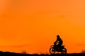 Black silhouette Motocross rider on a motorcycle in front of colorful sunset Royalty Free Stock Photo