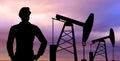 Black silhouette of oil worker and pump jack Royalty Free Stock Photo