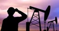 Black silhouette of oil worker and pump jack Royalty Free Stock Photo