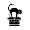 Black silhouette of the sitting cat on a flue.