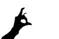 Black silhouette of a strange unknown bird with a beak from human fingers