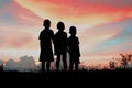 Black silhouette of three children standing together. Royalty Free Stock Photo