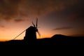 Windmill silhoutte on beautiful orange sunset background Royalty Free Stock Photo