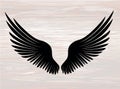 Black silhouette Wings. Vector illustration on wooden background