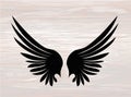 Black silhouette Wings. Vector illustration on wooden background