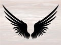 Black silhouette Wings. Vector illustration on wooden background