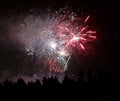 black silhouettes of people watching the show of fireworks Royalty Free Stock Photo