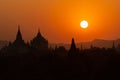 Black silhouettes of temples and trees at sunset at Bagan