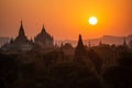 Black silhouettes of temples and trees at sunset at Bagan