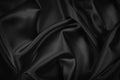 Black silk satin texture background. Beautiful wavy soft folds on shiny smooth fabric. Anniversary, event, card, invitation, conce Royalty Free Stock Photo