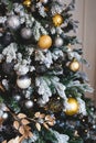 black, silver and gold Christmas tree decorations on the branches Royalty Free Stock Photo