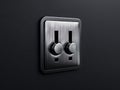 A black and silver light switch on a black wall Royalty Free Stock Photo