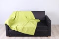 Black simple couch with green plaid