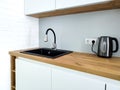 Black sink with flexible faucet in Scandi kitchen interior Royalty Free Stock Photo