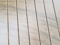 Black skid marks or lines on wood deck