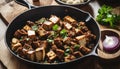 A black skillet filled with food on a wooden table