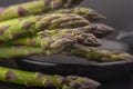 Black skillet with fresh raw asparagus spears Royalty Free Stock Photo