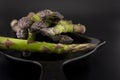 Black skillet with fresh raw asparagus spears Royalty Free Stock Photo