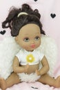 Black skin doll wearing angel suit and wings, girl Royalty Free Stock Photo