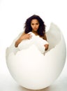 Black skined woman in big crashed egg Royalty Free Stock Photo