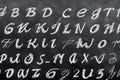 Black slate blackboard, with alphabetic and numeric characters written in white chalk. Concept of back to school, learning,
