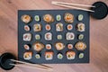 Black slate board with sushi with bowls with soy sauce and chopsticks for sushi Royalty Free Stock Photo