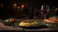 a black slate with hot italian spaghetti with pesto on the left side of a long Oak wood table Royalty Free Stock Photo