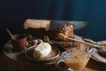 Black sliced bread on the board, vintage knife, butter and honey, flax seed, than slicing bread on the table and a wooden backgrou Royalty Free Stock Photo