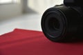 Black SLR camera with a lens on a red background Royalty Free Stock Photo