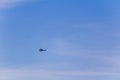 Black small helicopter flying against blue sky Royalty Free Stock Photo