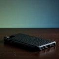 Black smartphone case on a wooden surface. Royalty Free Stock Photo