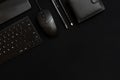 Black smartphone, keyboard, pencil, pen, wallet and black computer mouse on a black background. Business items. Low key photo. Royalty Free Stock Photo