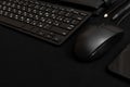 Black smartphone, keyboard, pencil, pen, wallet and black computer mouse on a black background. Business items. Low key photo. Royalty Free Stock Photo