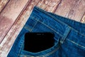 Black smartphone sticking out of his jeans pocket Royalty Free Stock Photo