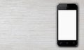Smartphone with white blank screen lying on a wooden table Royalty Free Stock Photo