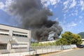 Black smoke from a blaze in a warehouse