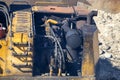 Black smoking exhaust pipe of old excavator