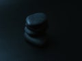 Black smooth snones on dark background. Royalty Free Stock Photo