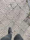 Black sneaker and broken sidewalk