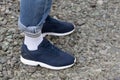 Black sneakers and boyfriend jeans close up. Casual style. Sports shoes