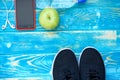 Black sneakers, green apple, drinking water Royalty Free Stock Photo