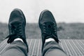 Black sneakers on legs, shoes Royalty Free Stock Photo