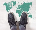 Black Sneakers on a World Map Outline Royalty Free Stock Photo