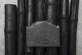 Black soap bar with bamboo charcoal and bamboo coal on grey background Royalty Free Stock Photo