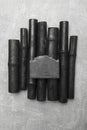 Black soap bar with bamboo charcoal and bamboo coal on grey background Royalty Free Stock Photo