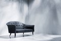 Black sofa in empty room with white wall Royalty Free Stock Photo