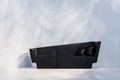 Black sofa in empty room with white wall. Lights and shadows Royalty Free Stock Photo